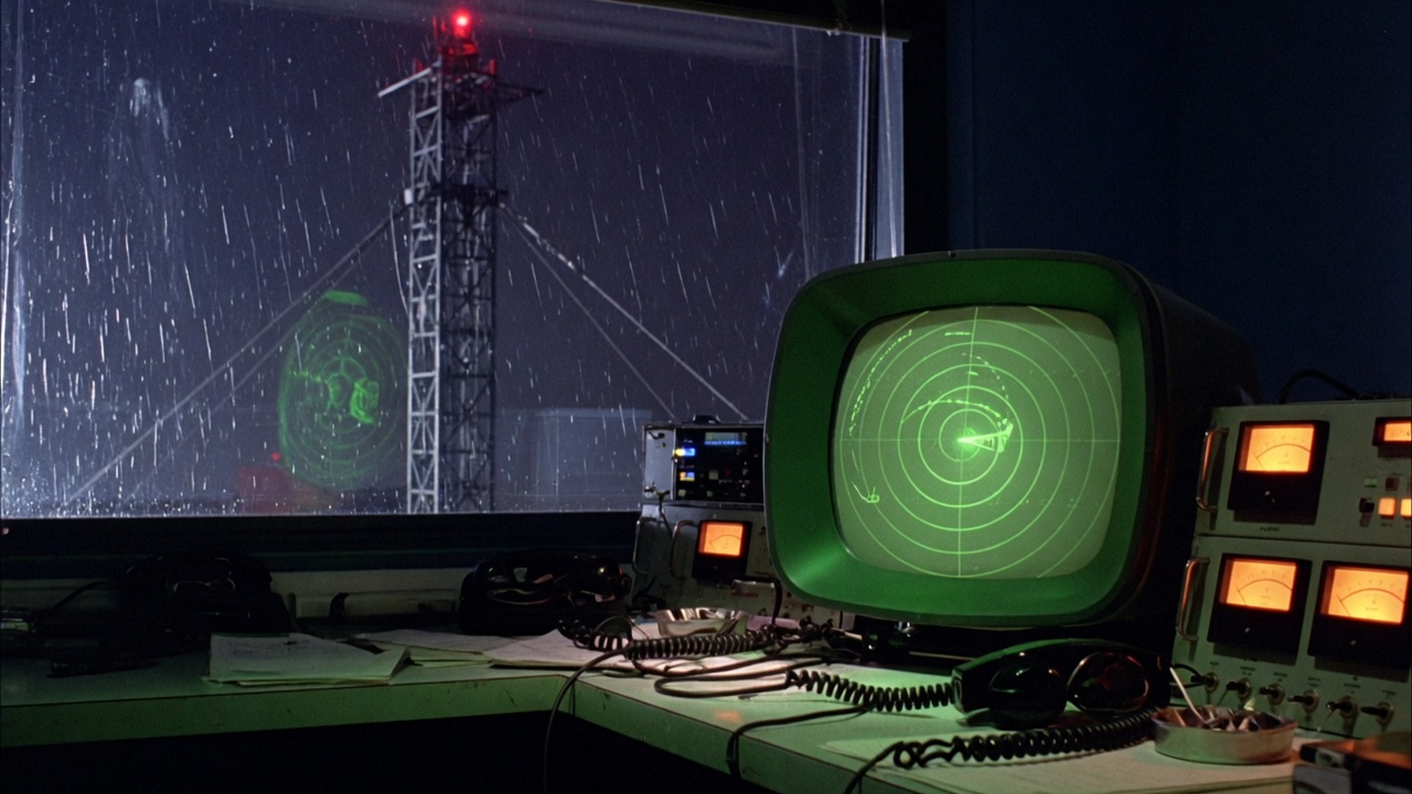 Night radio room with a phosphor CRT and a lattice mast outside
